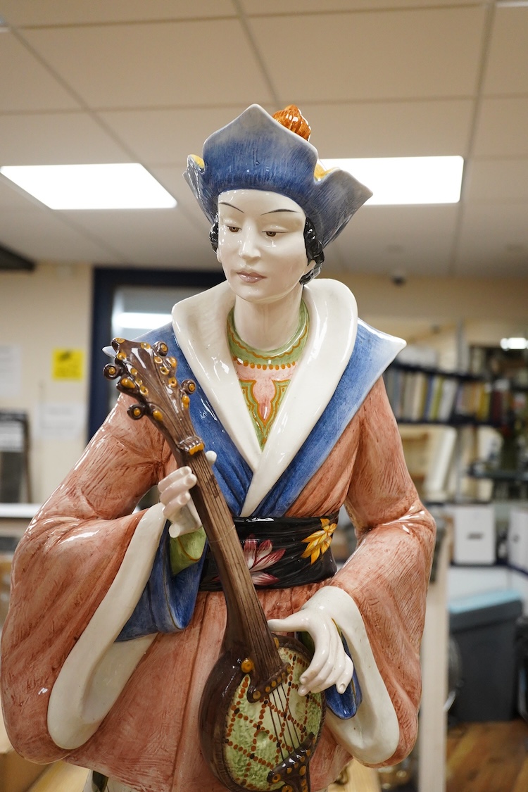D. Polo Uiato, a pair of large ceramic figurines, Geisha girls, signed, 86cm high